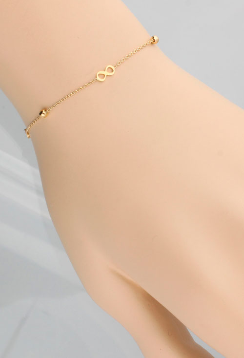 pulsera oro 18k bolas y simbolos de infinito foto vista en maniqui