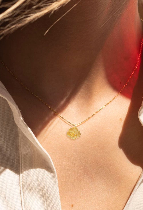 medalla oro amarillo 18 kilates forma de nube con angelote foto con modelo